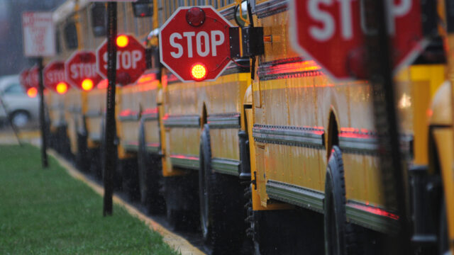 Row of school buses with Stop arms